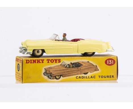 A Dinky Toys 131 Cadillac Tourer, pale yellow body, cerise interior, grey driver, light beige hubs, in original box, E, small