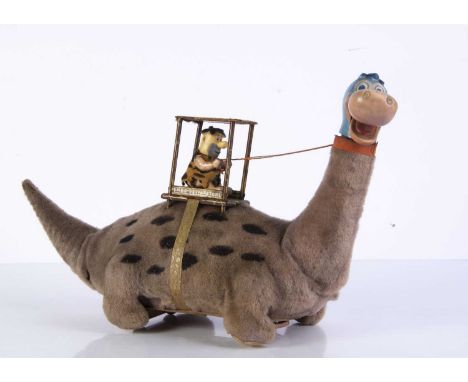 A Marx Toys (Japan) Battery-Operated Fred Flintstone On Dino, 1960's tinplate toy, purple plush covered Dino with black spots