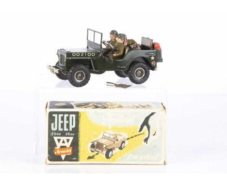 An Arnold Tinplate Clockwork US Army Jeep 2100, military green body, khaki seats, 'J2100' reg, petrol can and spare wheels, t