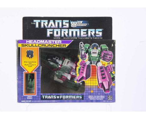 Vintage Hasbro Transformers G1 Decepticon Headmaster Skullcruncher, in original box, opened bubble, complete with Grax Traine