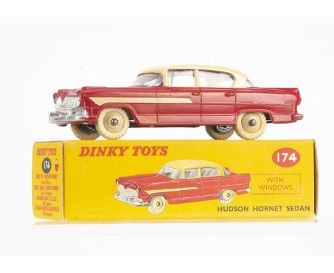 A Dinky Toys 174 Hudson Hornet Sedan, red lower body, cream roof and side flash, light beige hubs, in original box, E, just s