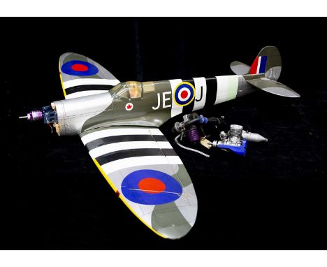 A Radio Controlled kit built Spitfire and two spare combustion aero engines (3), constructed in wood with a decorated plastic