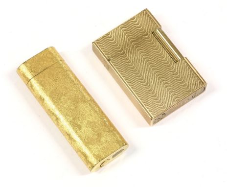 A gold-plated Cartier cigarette lighter, of ovoid form, brush textured exterior, no. 176343, signed 'Cartier, Paris', anda go