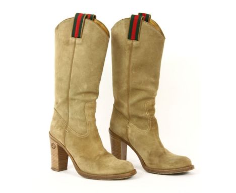 A pair of light brown tan suede knee-high boots,with classic techno banding to the tops, smooth tan leather and double 'G' lo