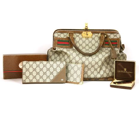 A vintage Gucci handbag,double 'G' canvas, with techno ribbon and a gold-tone clasp, a vintage Gucci wallet,with sectioned in