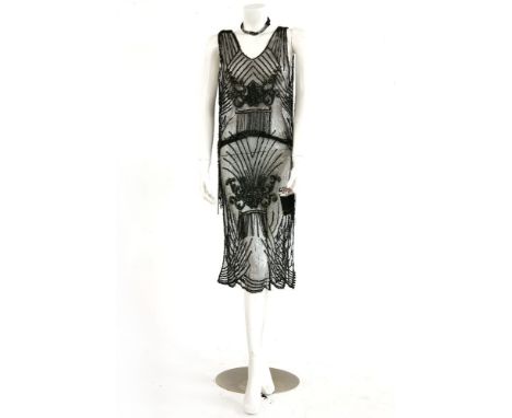 An original 1920s black tulle flapper dress,with black sequin detailing throughout, a silver sequin panel to the front and ba