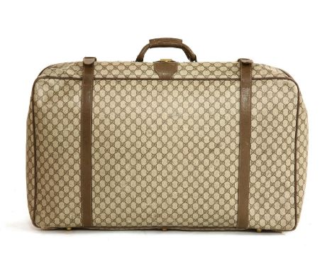 A Gucci vintage medium-sized suitcase,printed with the brand's iconic motif, constructed from a durable coated canvas with da