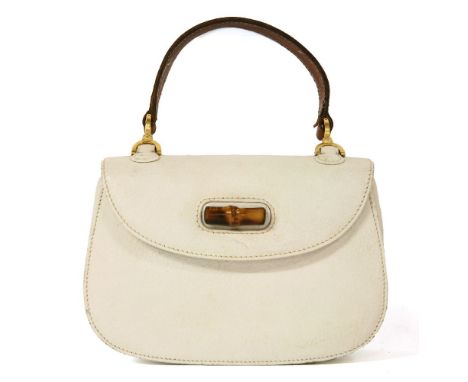 A vintage Gucci white leather handbag,with classic bamboo twist lock, replacement handle, cream leather interior, with zip po