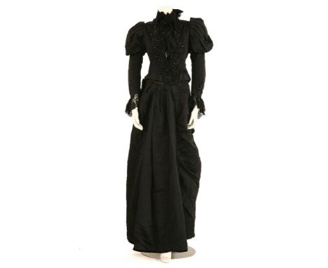 A Victorian black silk dress consisting of a bodice, skirt and cape,all pieces highly embellished with beadwork and black bob