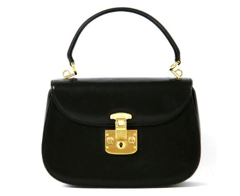 A vintage Gucci black leather handbag, gold-tone lock, clasp engraved 'Gucci', with single dual roll handle, gold-tone hardwa