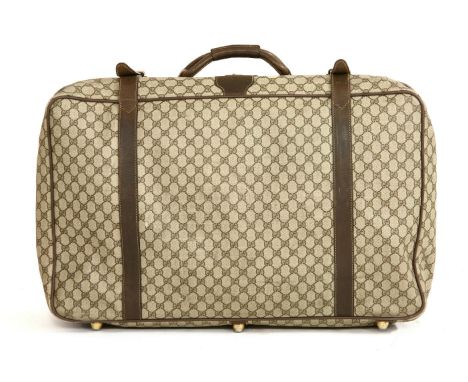 A Gucci vintage small-sized suitcase,printed with the brand's iconic motif, constructed from a durable coated canvas with dar