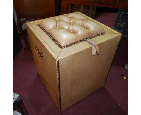 An early 20th century stud bound leather clad ottoman, with button down leather upholstered seat/lid, H.56 W.46 D.46cm 