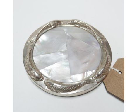 A mother of pearl and silver plated coaster, with mother of pearl center within silver plated rim decorated with fish, Diamet