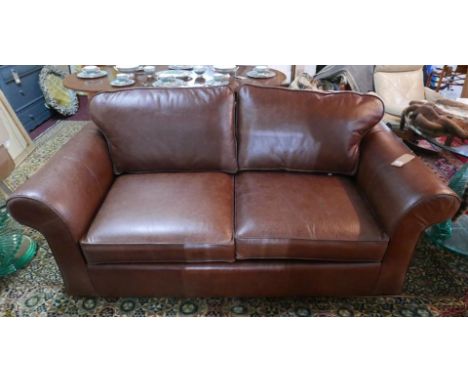 A brown leather sofa bed 