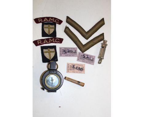 A box containing a military compass dated 1940, A Metropolitan whistle &amp; assorted patches 