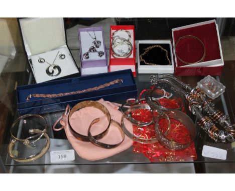 A shelf full of silver &amp; gold tone jewellery 