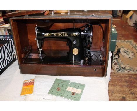 A vintage Singer electric sewing machine (missing foot pedal) 