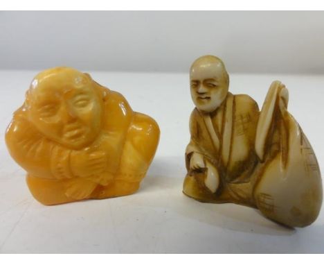 A small ivory netsuke &amp; carved amber Buddha 