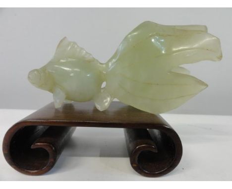 A carved jade dish on a wooden stand (slight damage) 
