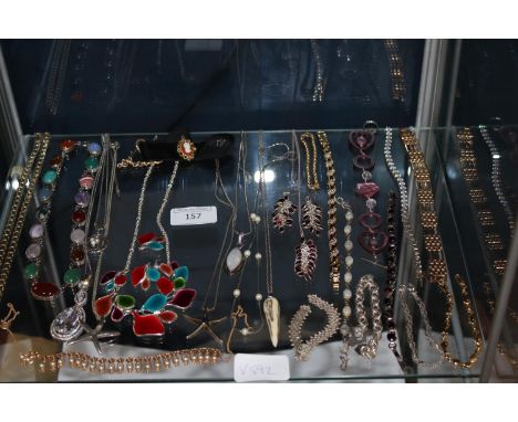 A shelf full of silver &amp; gold tone jewellery 