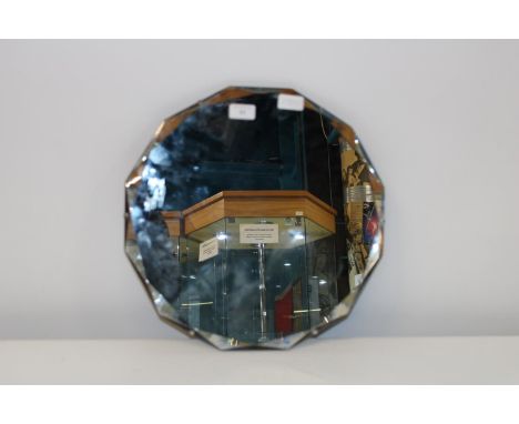A vintage bevelled edged mirror 42cm in diameter 