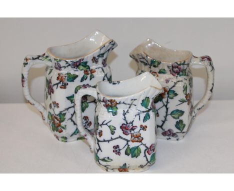 Three antique graduated ceramic jugs largest 19cm tall 