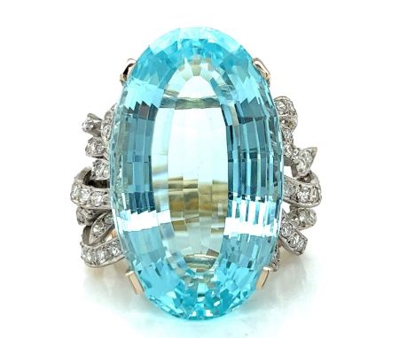 18K Yellow &amp; White Gold 62.40 Ct. Aquamarine Ring.           Weighing 25.6 grams Set with a 62.40 Ct. Aquamarine in Cente