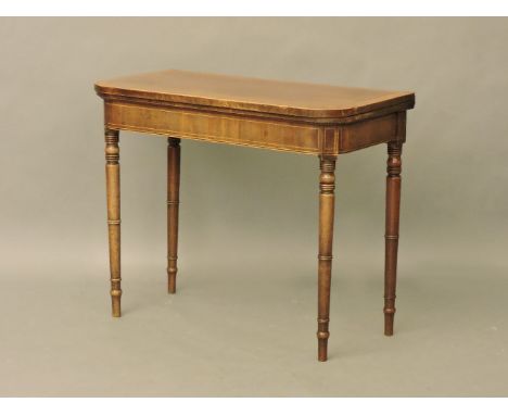 A George III strung and crossbanded mahogany fold over card table, of D shape, on turned legs, 90cm wide