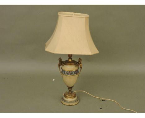 A French alabaster and champleve  table lamp, with gilt winged maiden handles and a cream shade, 75cm high