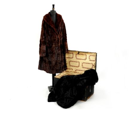 A 19th century pine and canvas trunk, with original lining paper, containing a black mink fur coat and a Canadian squirrel fu