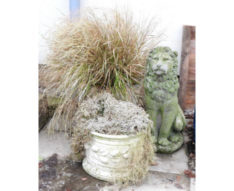 A reconstituted stone figure of a seated lion, 82cm high, together with a large basket weave planter and a squat cylindrical 