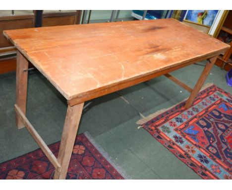 A wooden vintage folding trestle table