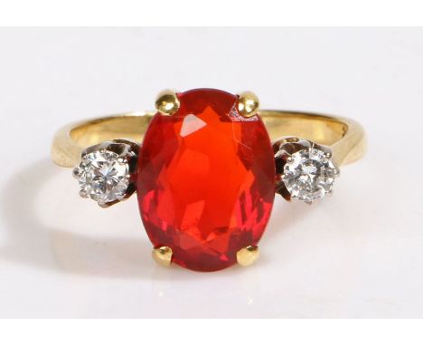 An 18ct yellow gold fire opal and diamond trilogy ring.Approx. fire opal carat weight: 2.20cts.Approx. total diamond carat we