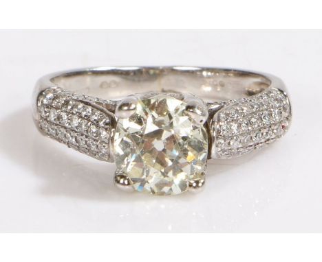 A platinum diamond ring with diamond set shoulders.Central diamond approx. carat weight: 1.30cts. Colour: J. Clarity: SI1.Sur