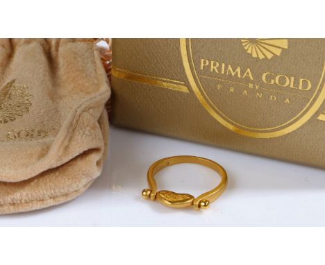 A 24ct yellow gold swivel heart ring by PrimaGold.With paperwork and a bag from PrimaGold.Ring size K 1/2.Weighing 4.30 grams