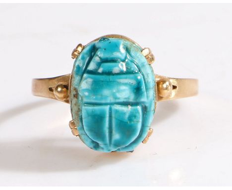 A 9ct yellow metal carved blue scarab beetle ring. Approx. 13.5 x 10mm.Ring size P.Weighing 2.80 grams.Used, in good conditio