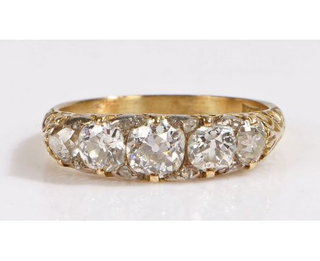 An 18ct yellow gold Victorian style diamond ring with five diamonds.Central diamond approx. carat weight: 0.60cts.Two diamond
