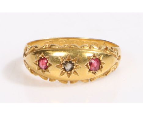 An 18ct yellow gold gypsy style ring with one ruby and two diamonds.Approx. total carat weight of rubies: 0.10cts.Ring size K