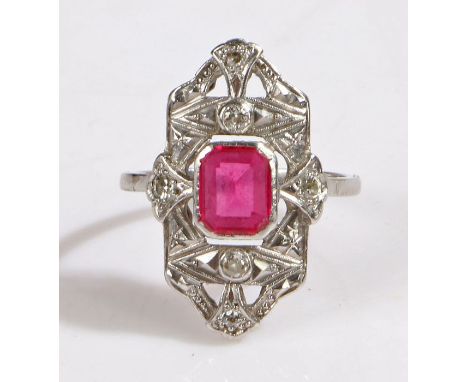 An art deco platinum ruby and diamond cluster ring.Rectangular cut ruby approx. 7.5 x 6.1 x 2.65mm.Total approx. diamond cara