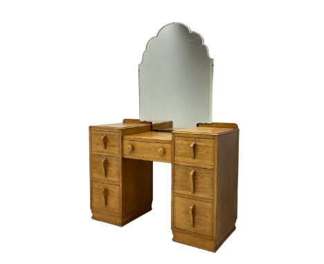 Mid-20th century light oak twin pedestal dressing table, shaped mirror back, fitted with seven drawersDimensions: Height:&nbs