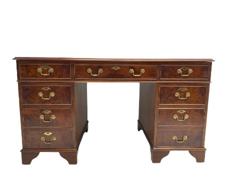 Figured walnut twin pedestal desk, moulded rectangular top with leather inset, fitted with eight drawers, on bracket feetDime