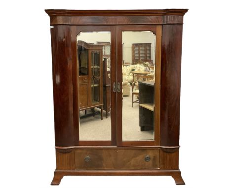 Late 19th century mahogany double wardrobe, projecting cornice over figured frieze, curved uprights enclosing two doors with 