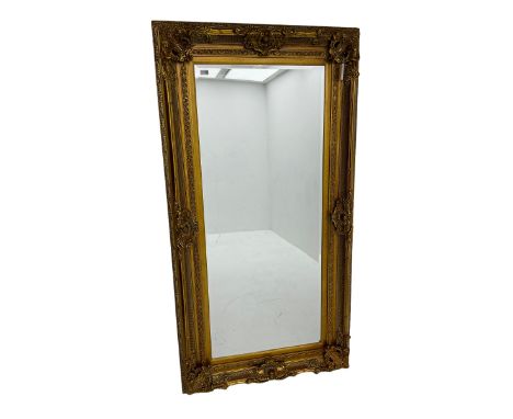 Gilt framed mirror, the frame decorated with shell cartouches and floral scrolls, bevelled plate 181cm x 85cmDimensions: Heig