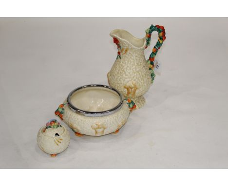 Clarice Cliff jug, condiment pot and bowl, height of jug 28 cm