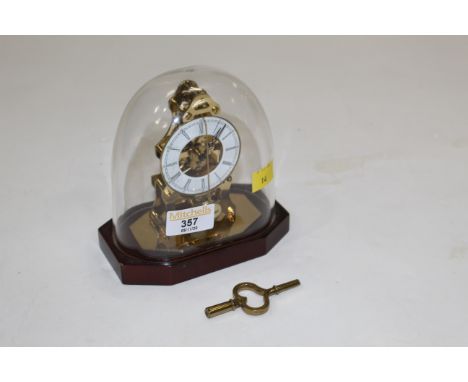 Miniature French "Du Chateau" skeleton mantle clock with plastic dome, height including dome 15 cm