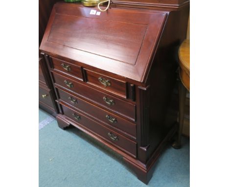 A reproduction mahogany bureau with fitted interior with two small drawers over three drawers on bracket feet, 87cm high x 74
