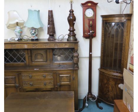 A reproduction mahogany serpentine front corner cabinet with single glazed door over a door, 180cm high x 60cm wide, A London