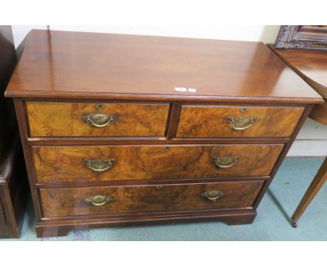 A Victorian mahogany and walnut two over two chest of drawers with brass handles on bracket feet, 78cm high x 106cm wide x 50