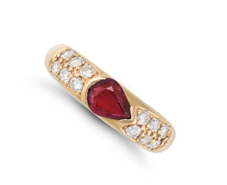 A RUBY AND DIAMOND RING in yellow gold, set with a pear cut ruby, accented by two rows of round brilliant cut diamonds, no as