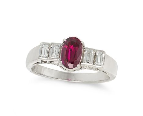 A RUBY AND DIAMOND RING in 14ct white gold, set with an oval cut ruby between four baguette cut diamonds, over a scrolled gal